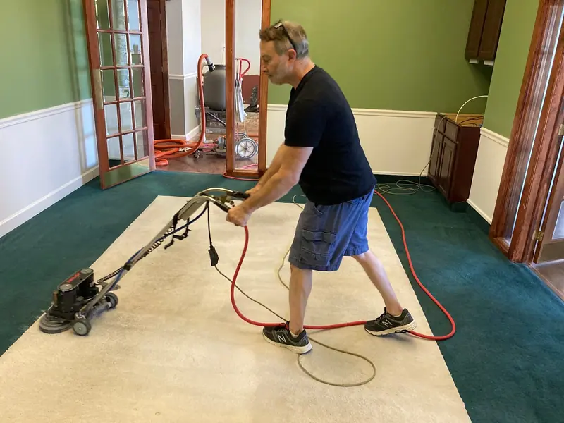 Cleaning a cream carpet in a room with green walls