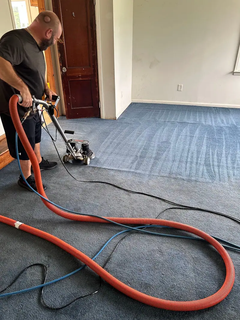 Cleaning blue commercial carpet in an empty room